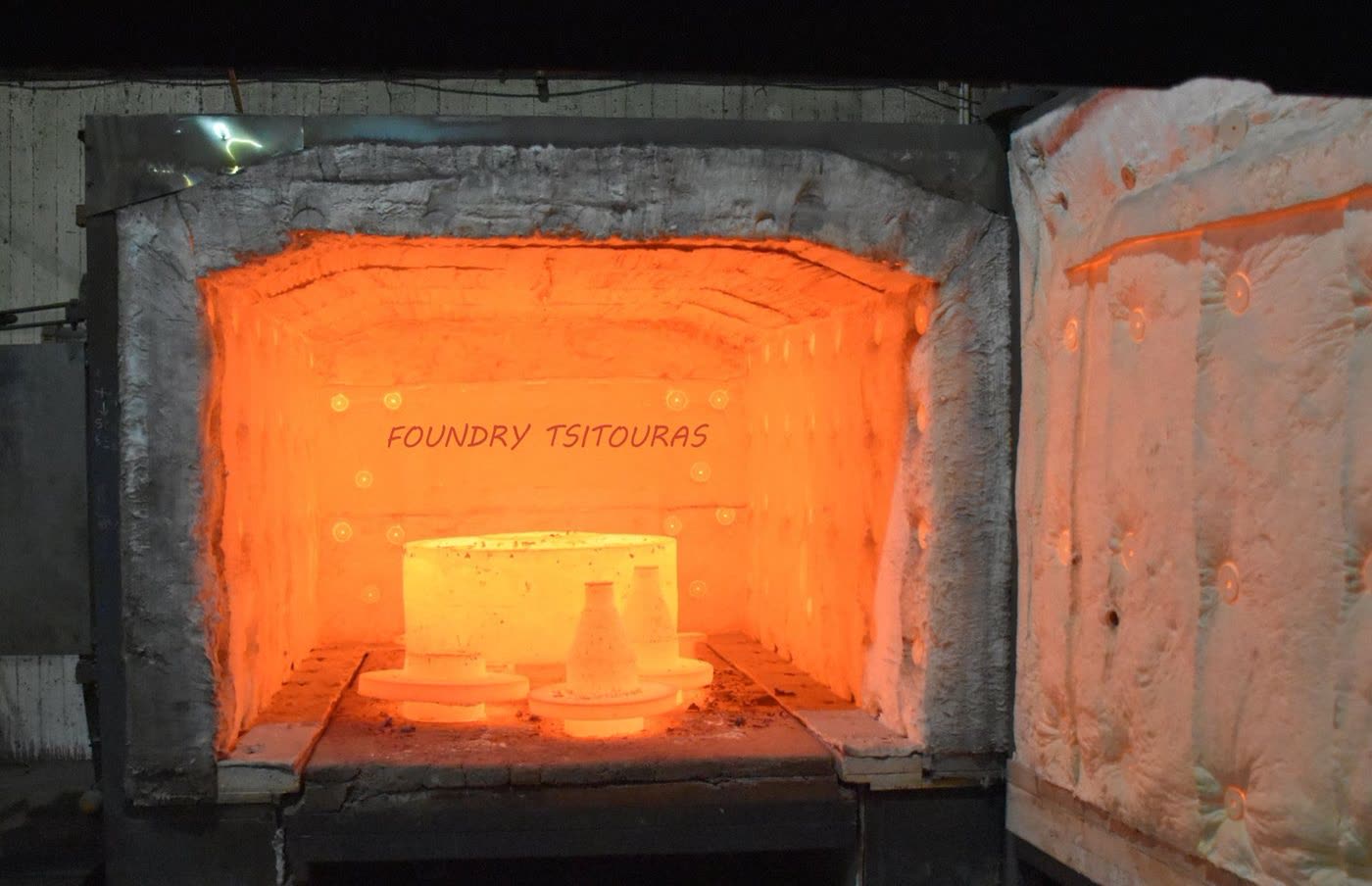 Open heat-treatment furnace glowing at temperature