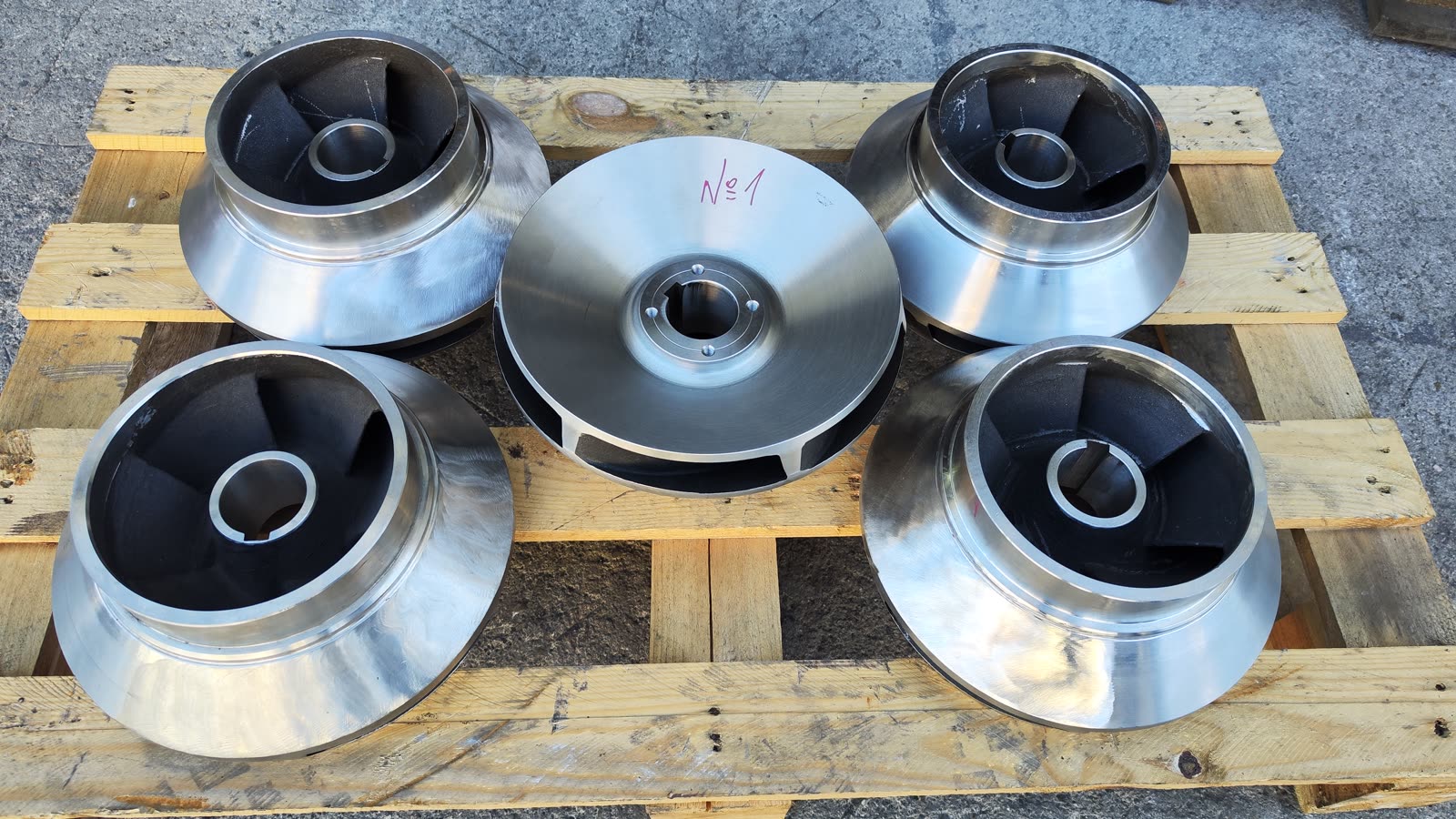 Stainless steel pump impellers on a pallet after machining